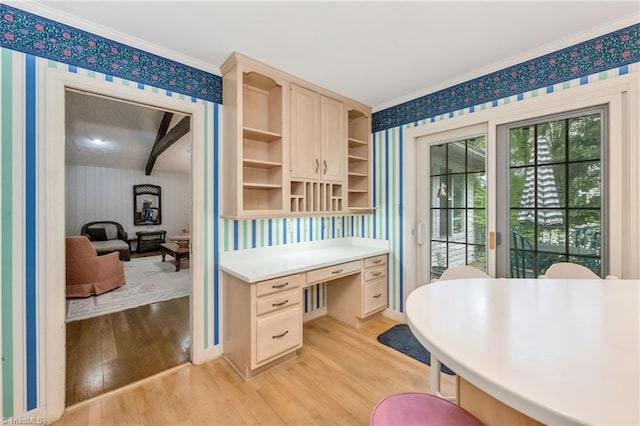 home office with crown molding, light wood-style flooring, and wallpapered walls