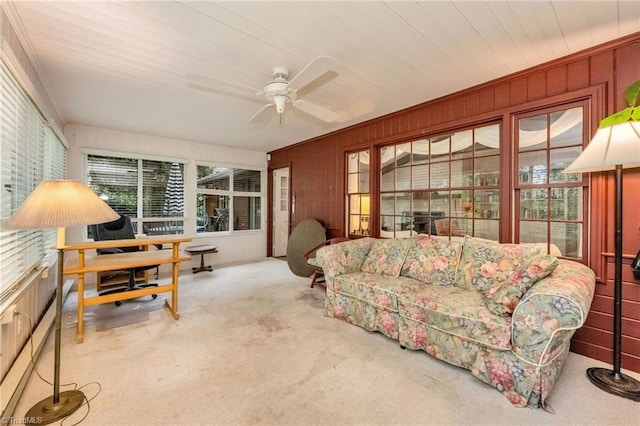 living room with a ceiling fan, a healthy amount of sunlight, and carpet