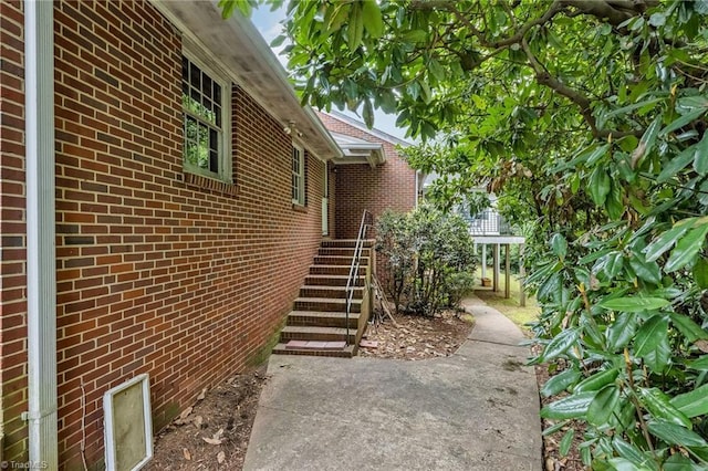 view of side of property with brick siding