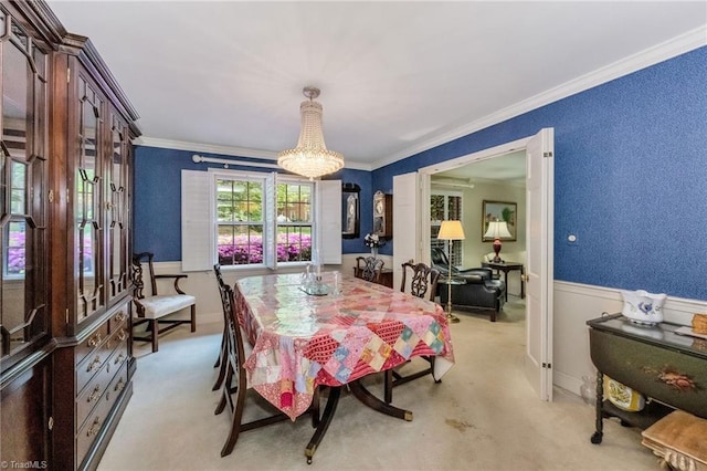 dining area featuring a chandelier, light carpet, and ornamental molding