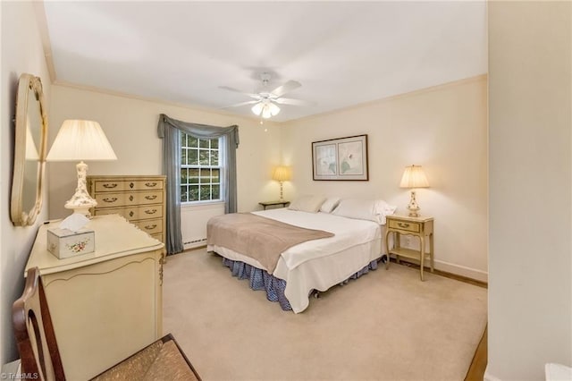 bedroom featuring crown molding, light carpet, baseboards, ceiling fan, and a baseboard heating unit