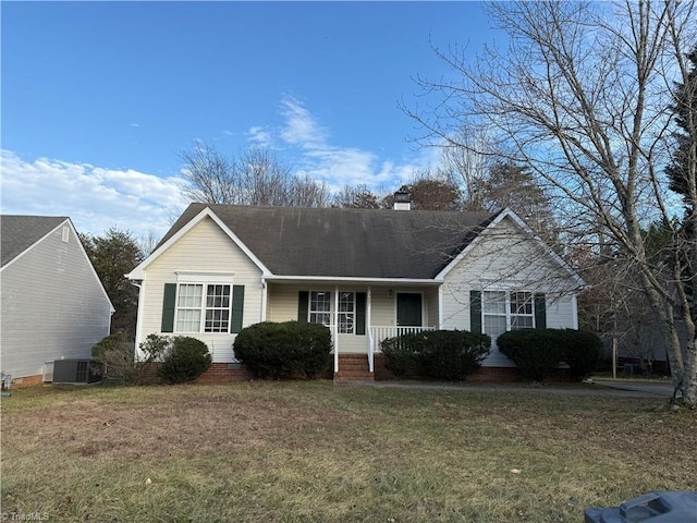 ranch-style house with cooling unit, covered porch, and a front lawn