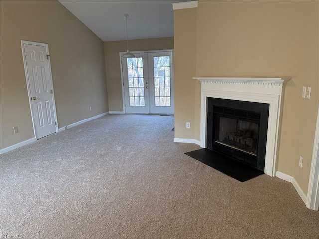 unfurnished living room with french doors, carpet floors, and lofted ceiling