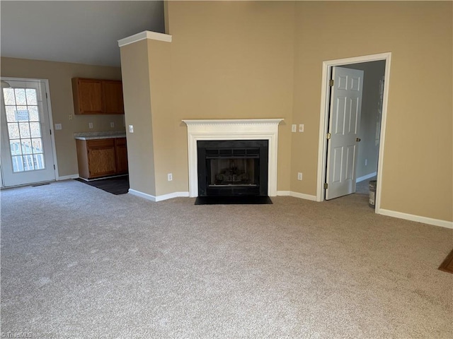 unfurnished living room featuring light carpet