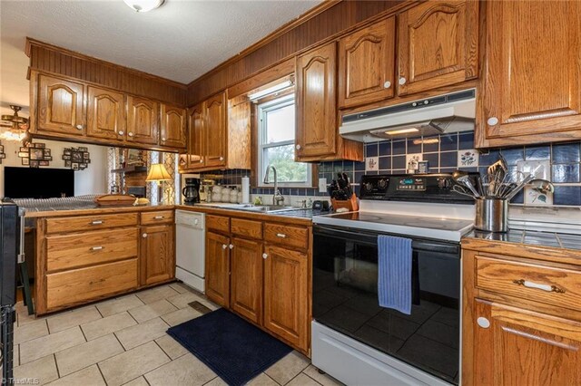 kitchen with white appliances, backsplash, sink, and light tile patterned flooring