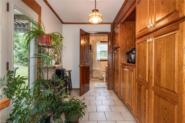 interior space featuring ornamental molding and light tile patterned floors