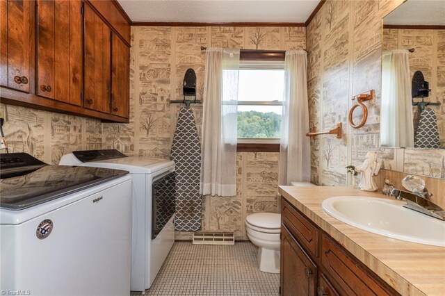 bathroom featuring tile patterned floors, toilet, separate washer and dryer, ornamental molding, and vanity