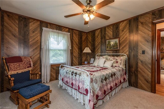 bedroom with ceiling fan and wooden walls