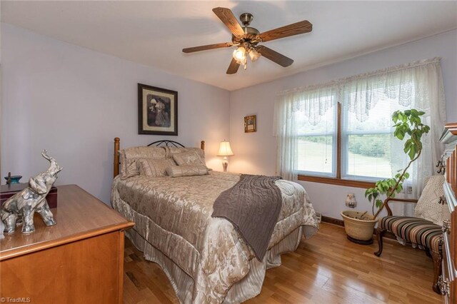 bedroom featuring light wood-type flooring and ceiling fan