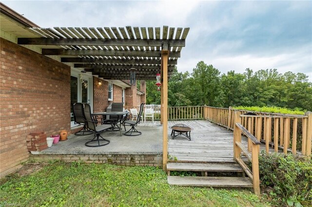 wooden terrace with a patio area and a pergola