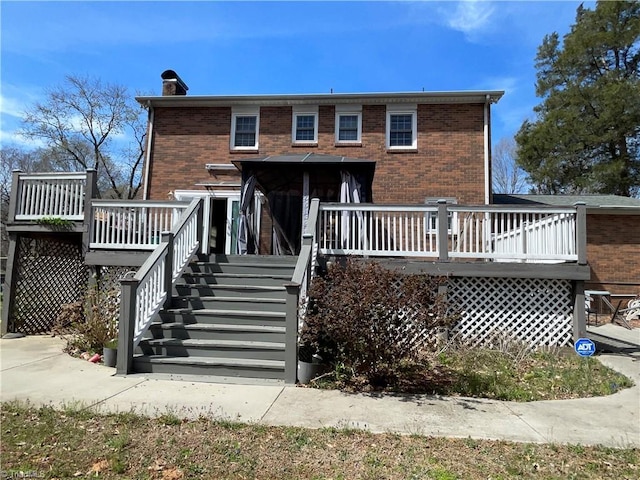 157 Peace Haven Rd N, Winston-Salem, NC 27104 - rear view of property featuring a deck, brick siding, a chimney, and stairway