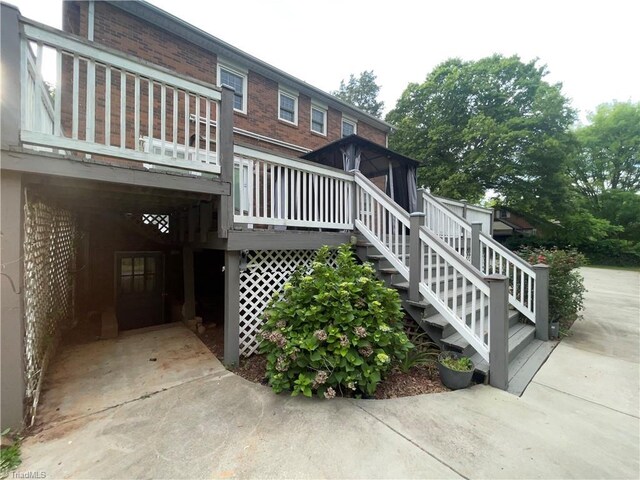 157 Peace Haven Rd N, Winston-Salem, NC 27104 - rear view of house with stairway, a deck, and brick siding