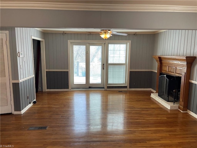 157 Peace Haven Rd N, Winston-Salem, NC 27104 - unfurnished living room featuring ceiling fan, crown molding, a fireplace with raised hearth, wood finished floors, and baseboards