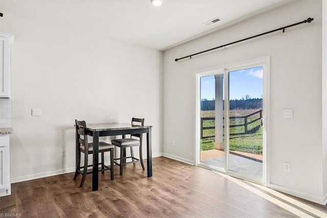 dining area with hardwood / wood-style floors