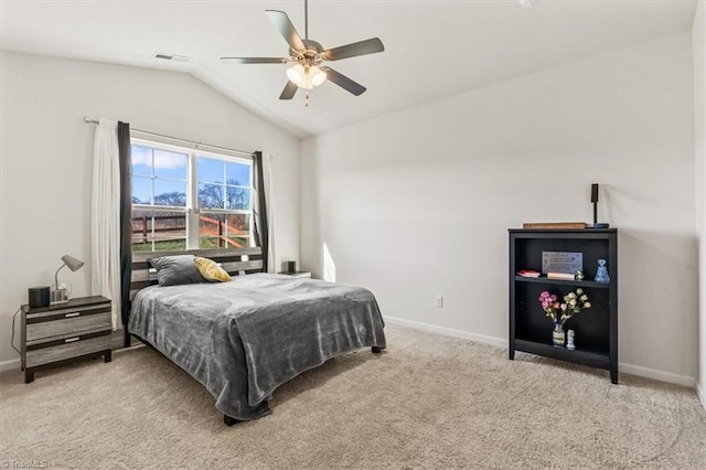 carpeted bedroom with ceiling fan and vaulted ceiling