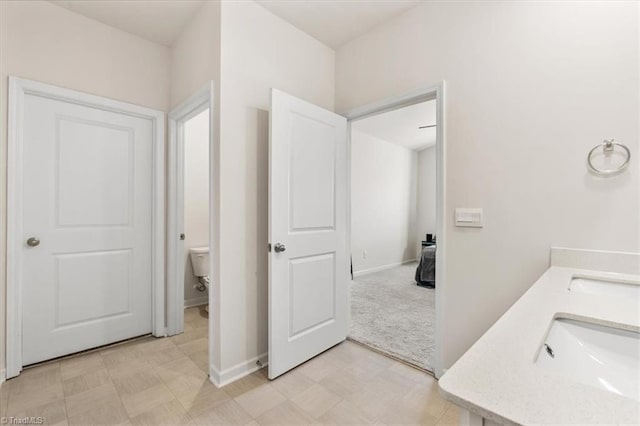 bathroom featuring toilet and vanity