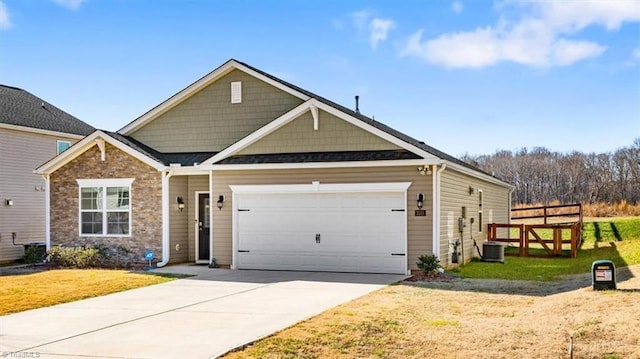 view of front facade with cooling unit, a front yard, and a garage