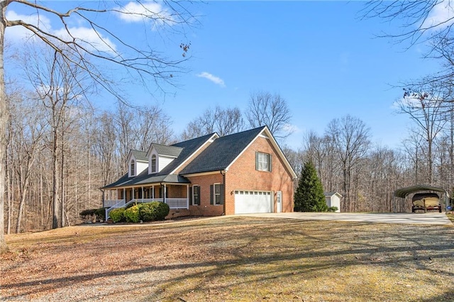 view of front of house featuring covered porch, a front lawn, a garage, and a carport