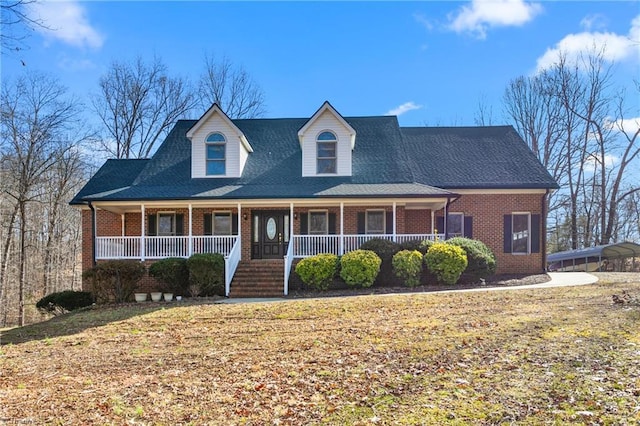 view of front of house with covered porch and a front lawn