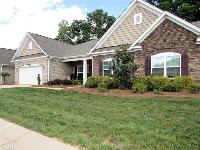 view of front facade featuring stone siding, a front lawn, a garage, concrete driveway, and roof with shingles