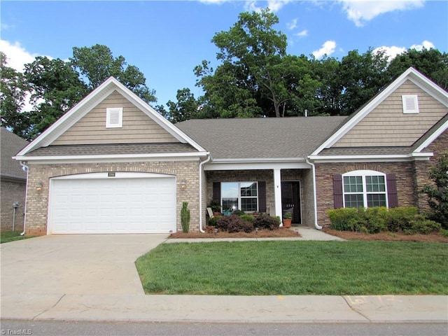 craftsman inspired home with concrete driveway, a front yard, a garage, and a shingled roof