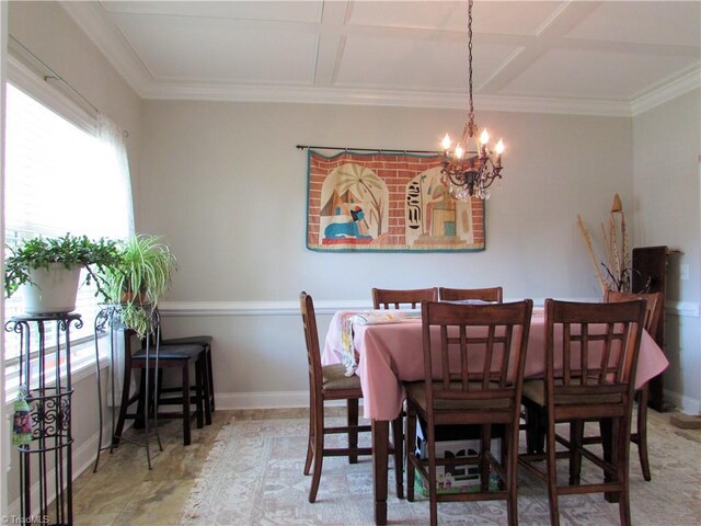 dining area featuring a chandelier, ornamental molding, and baseboards
