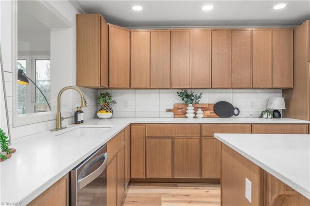 kitchen with dishwasher, sink, and backsplash