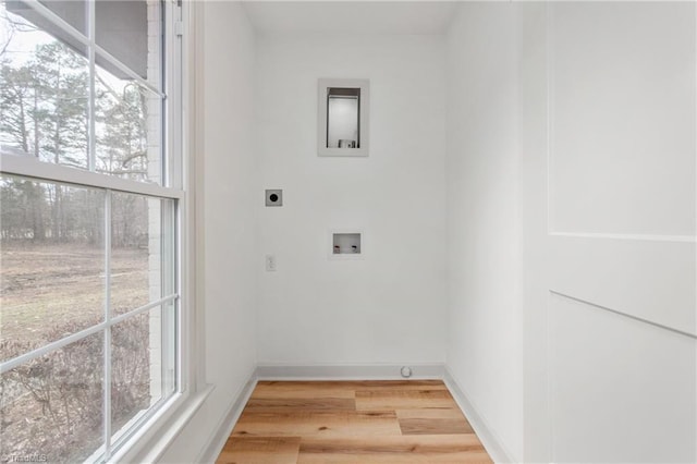 washroom featuring hardwood / wood-style flooring, washer hookup, and hookup for an electric dryer