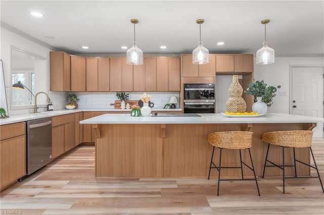 kitchen with double oven, tasteful backsplash, sink, a center island, and stainless steel dishwasher