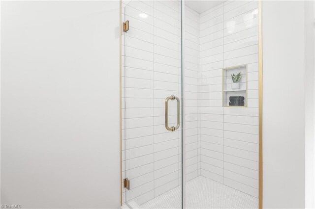 bathroom featuring a shower with shower door
