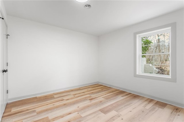 spare room featuring light hardwood / wood-style floors
