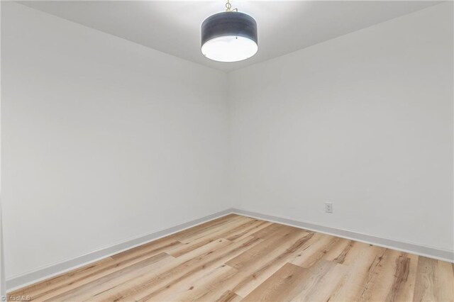 unfurnished room with hardwood / wood-style floors