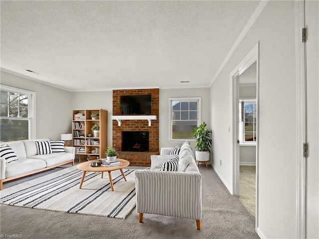 carpeted living room featuring ornamental molding, a textured ceiling, and a fireplace