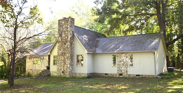 view of property exterior featuring central air condition unit and a lawn