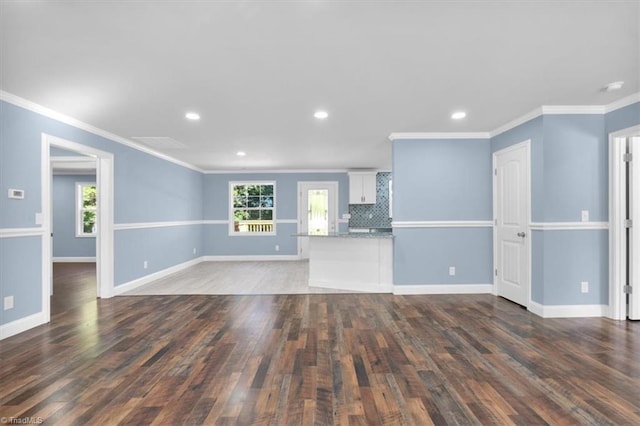 unfurnished living room with dark wood-type flooring and ornamental molding