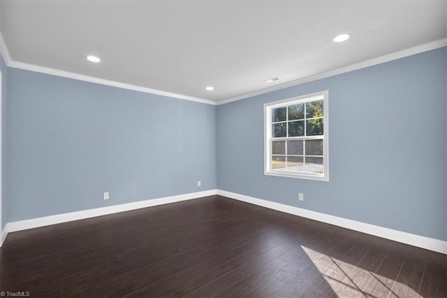 unfurnished room featuring ornamental molding and dark wood-type flooring