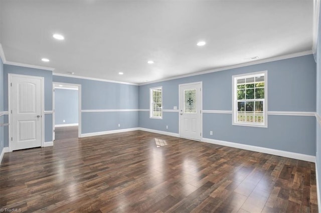 empty room featuring ornamental molding and dark hardwood / wood-style flooring