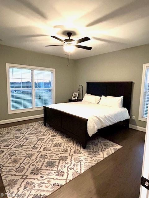 bedroom with ceiling fan and hardwood / wood-style floors