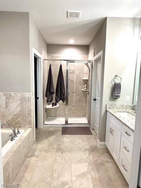 bathroom featuring shower with separate bathtub and vanity