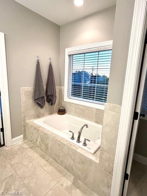 bathroom featuring tiled tub