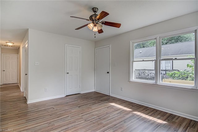 unfurnished room with ceiling fan and hardwood / wood-style floors