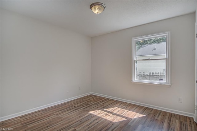 empty room featuring dark hardwood / wood-style flooring