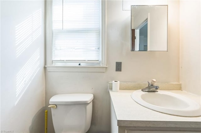 bathroom with toilet and vanity