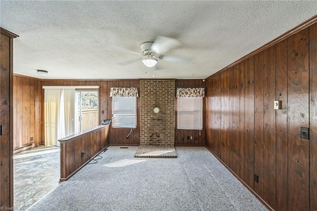 interior space featuring light colored carpet, a textured ceiling, and wooden walls