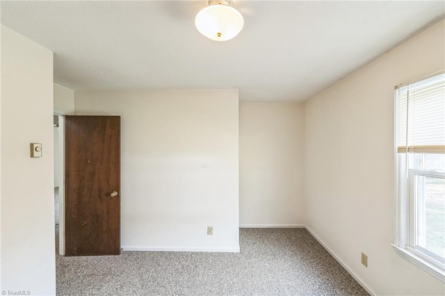 carpeted spare room with plenty of natural light