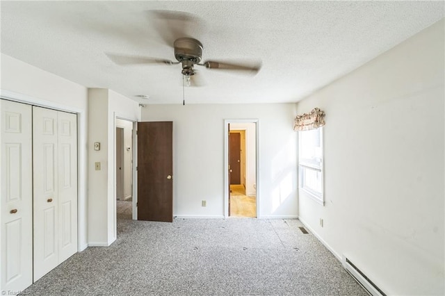 unfurnished bedroom featuring a baseboard radiator, a textured ceiling, a closet, ceiling fan, and light colored carpet