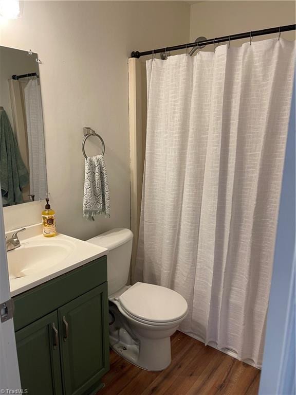 bathroom featuring vanity, toilet, and hardwood / wood-style floors