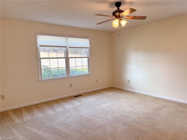 spare room featuring ceiling fan and light colored carpet