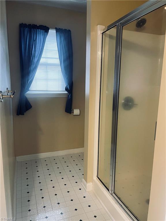 bathroom featuring an enclosed shower