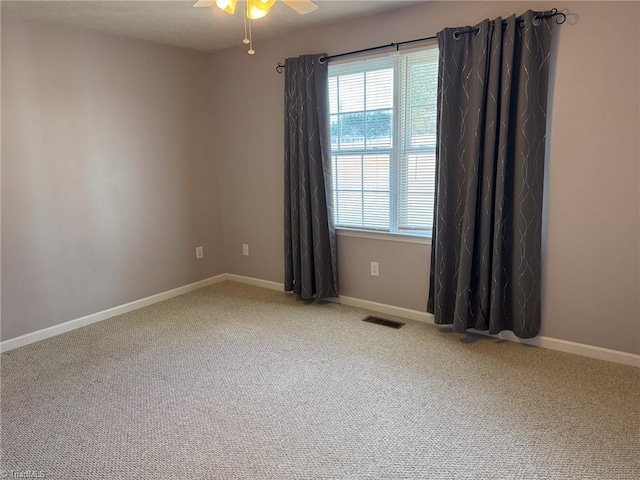 unfurnished room with ceiling fan and carpet floors